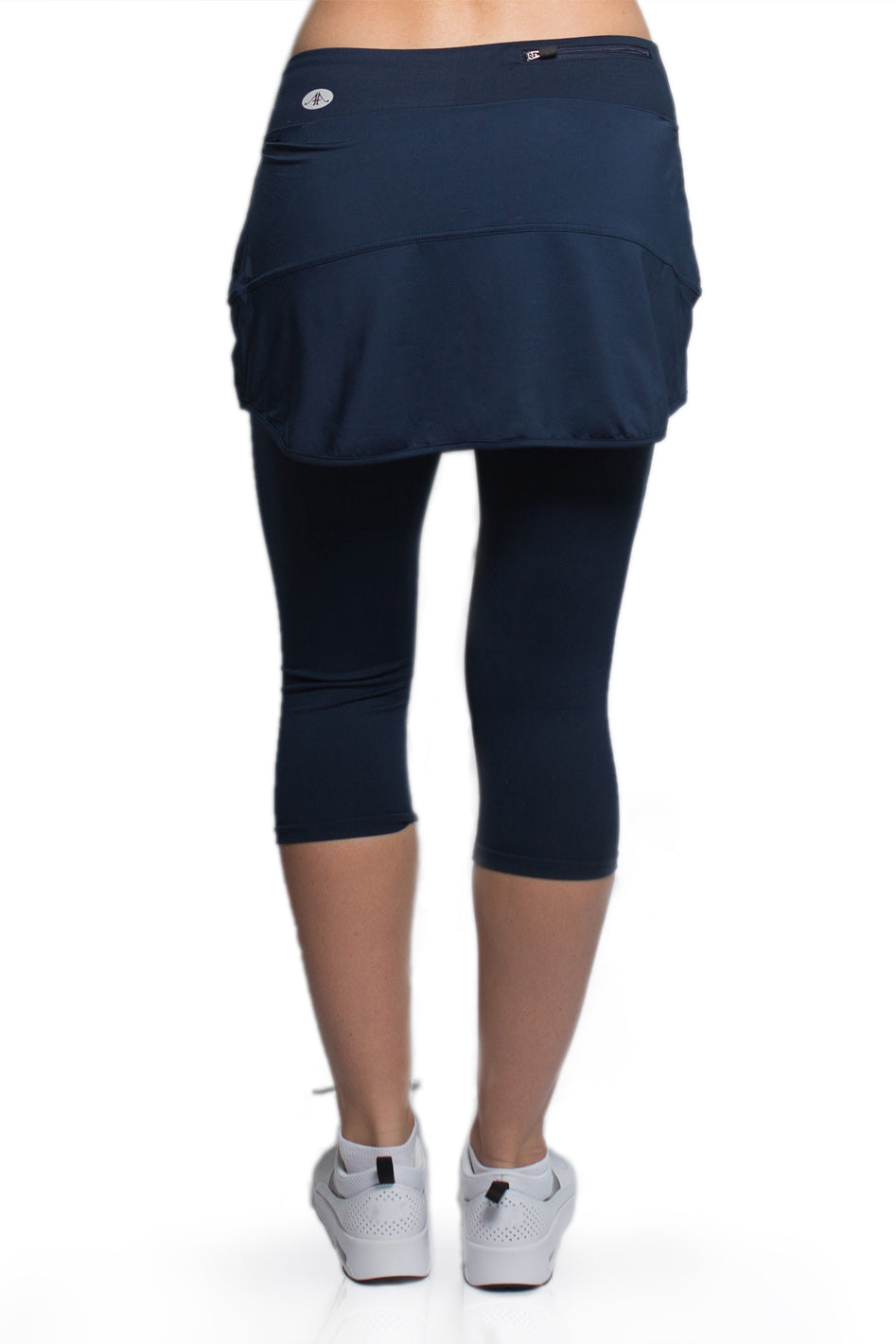 Rear view of a woman wearing the Alex + Abby Endurance Skirted Capri Legging in blue#color_true-blue