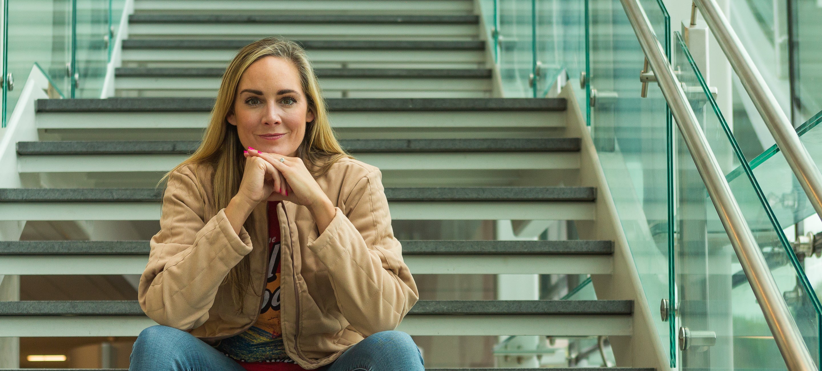 Confident and attractive woman sitting on stairs