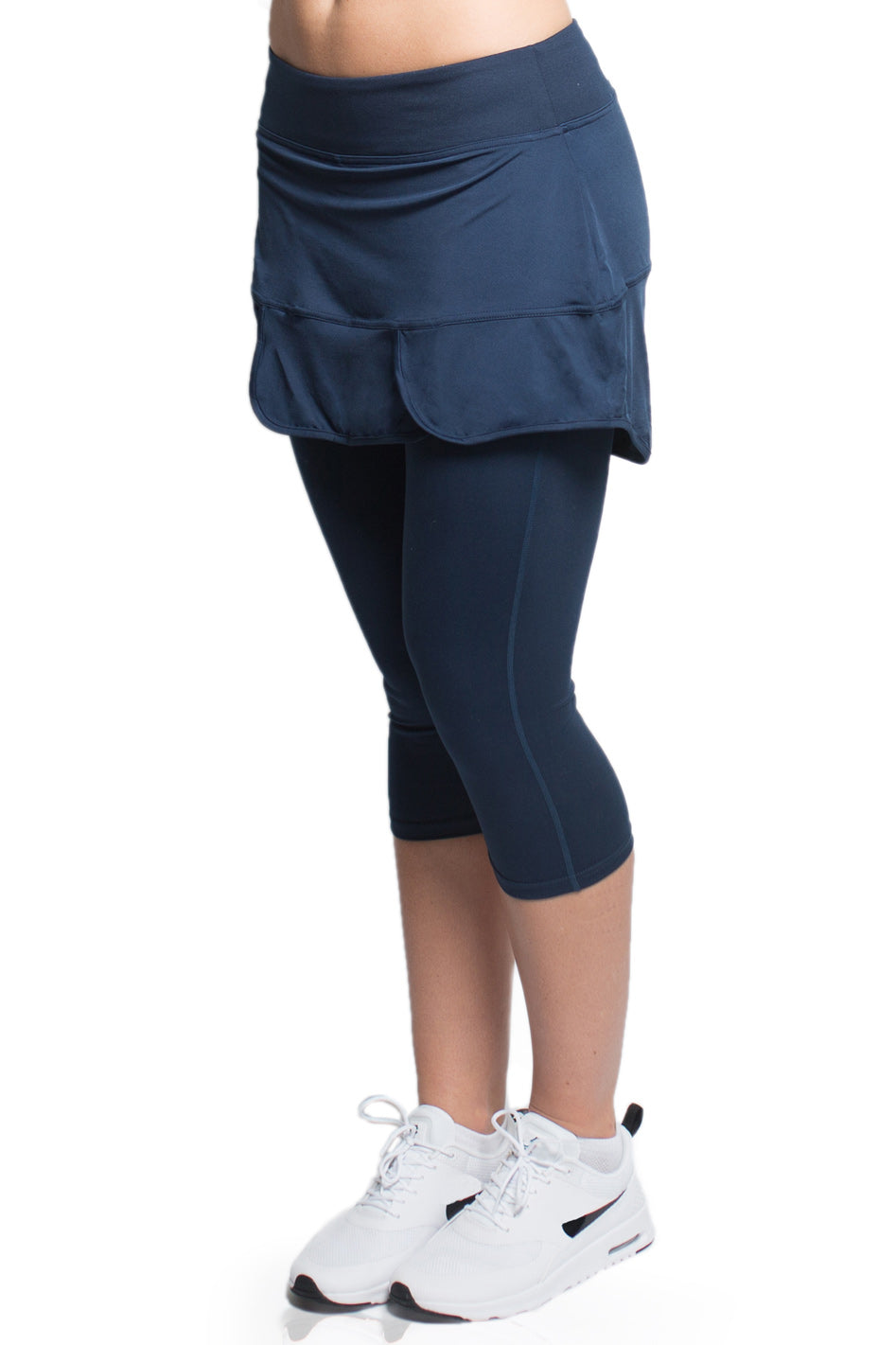 Side view of a woman dressed in the blue Alex + Abby Endurance Skirted Capri Legging