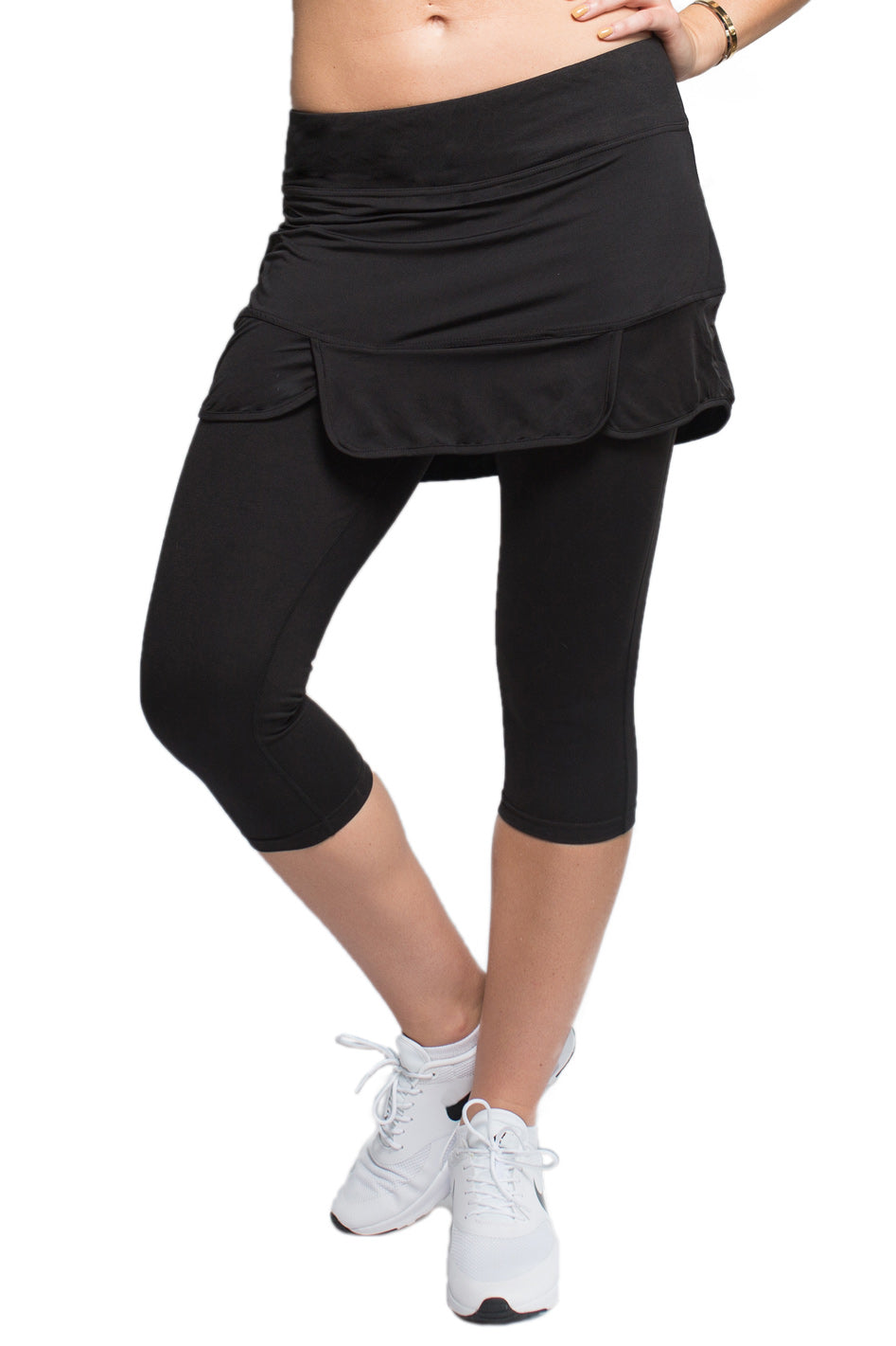 Female model in a black Endurance Skirted Capri Legging #color_black