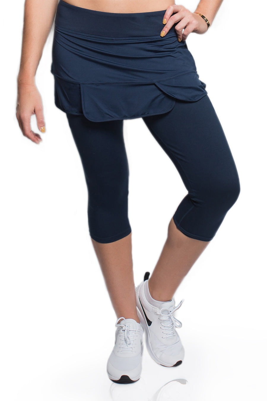 Woman demonstrating the fit of the Alex + Abby Endurance Skirted Capri Legging #color_true-blue